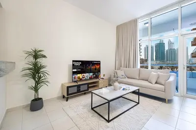 a living room with a couch and a tv at JuliusHomes - Studio in Bay Square, Business Bay Dubai in Dubai