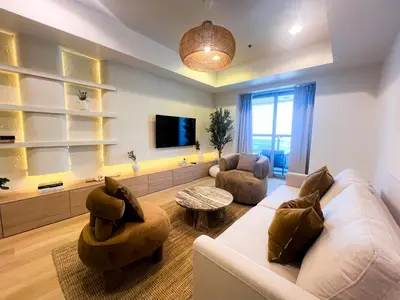 a living room with a couch and two chairs and a tv at Stunning 2BR In Dubai Marina With Amazing views in Dubai