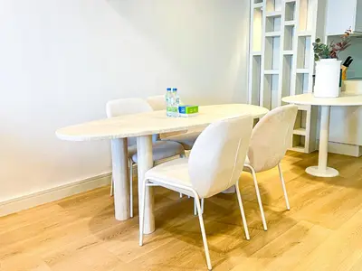 a wooden table with chairs and a table and a staircase at Stunning 2BR In Dubai Marina With Amazing views in Dubai