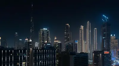 a nighttime view of a large city at night at Luxury 2BR apartment with Burj View GYM & Pool in Dubai