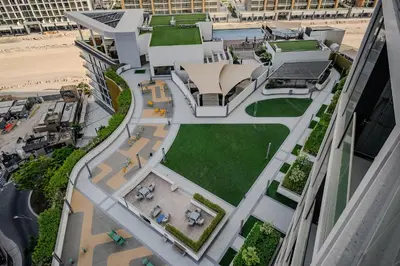 an aerial view of a building next to a beach at Stylish 1 BDR apartment in Sobha Waves in Dubai