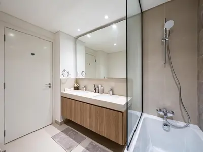 a bathroom with a tub and a sink and a shower at Chic 4 Bedroom Apartment I Burj Khalifa & Fountain Views I Direct Access to Dubai Mall I Free Gym, Pool, Parking Wi-Fi and PS5 I by Skyline Serenity in Dubai