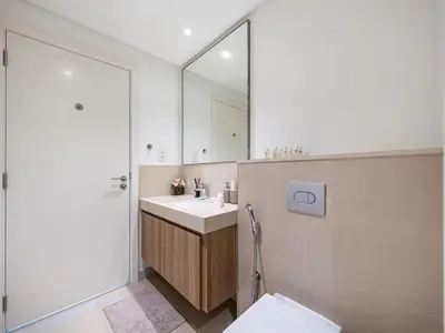 a bathroom with a sink and a mirror at Chic 4 Bedroom Apartment I Burj Khalifa & Fountain Views I Direct Access to Dubai Mall I Free Gym, Pool, Parking Wi-Fi and PS5 I by Skyline Serenity in Dubai