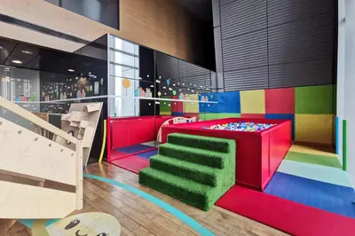 a colorful room with a bunk bed and a staircase at Blueground DIFC pool gym DXB-468 in Dubai