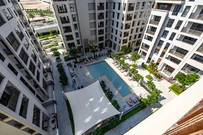 an overhead view of an apartment complex with a swimming pool at Exquisite 1BDR apartment in Creek with Pool View in Dubai