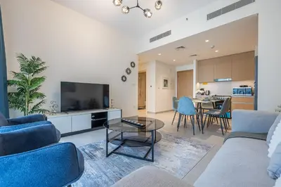 a living room with a couch and a table at Exquisite 1BDR apartment in Creek with Pool View in Dubai