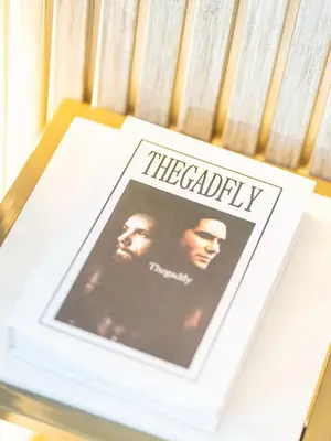 a book sitting on top of a table with a picture at Lavish 2 Bedroom I Burj Khalifa & Fountain Views I Free Gym, Pool, Parking, Wi-Fi and PS5 I by Skyline Serenity in Dubai
