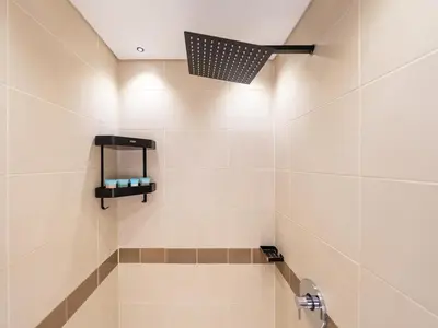 a bathroom with a shower with a light on the ceiling at Lavish 2 Bedroom I Burj Khalifa & Fountain Views I Free Gym, Pool, Parking, Wi-Fi and PS5 I by Skyline Serenity in Dubai