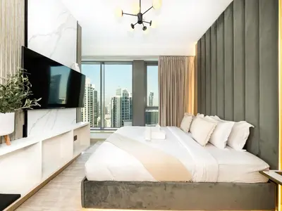a bedroom with a large bed and a large window at Lavish 2 Bedroom I Burj Khalifa & Fountain Views I Free Gym, Pool, Parking, Wi-Fi and PS5 I by Skyline Serenity in Dubai