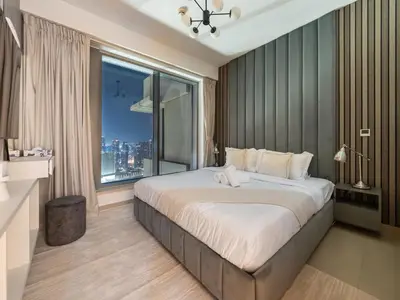 a bedroom with a large bed with a large window at Lavish 2 Bedroom I Burj Khalifa & Fountain Views I Free Gym, Pool, Parking, Wi-Fi and PS5 I by Skyline Serenity in Dubai