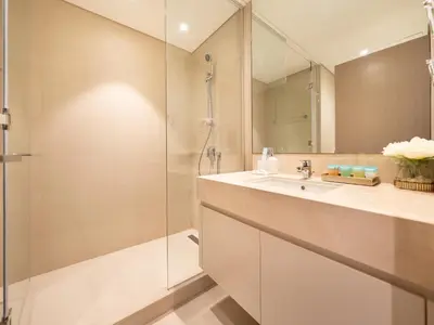 a bathroom with a shower and a sink at Skyline 2 Bedroom Apartment I Burj Khalifa & Fountain Views I Free Gym, Pool, Parking, Wi-Fi and PS5 in Dubai
