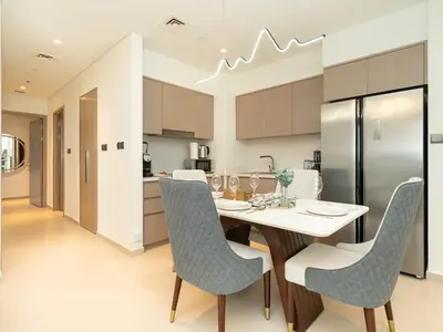 a kitchen and dining room with a table and chairs at Skyline 2 Bedroom Apartment I Burj Khalifa & Fountain Views I Free Gym, Pool, Parking, Wi-Fi and PS5 in Dubai