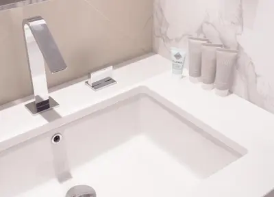 a bathroom with a white sink with a mirror at ADDRESS Residences Opera 2BR Tower 1 - EPIC 30th floor Burj Khalifa view byBLCK with DXB AIRPORT VIP Shuttle option in Dubai