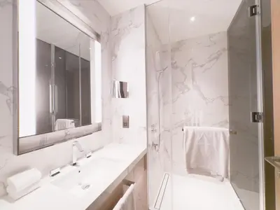 a white bathroom with a sink and a mirror at ADDRESS Residences Opera 2BR Tower 1 - EPIC 30th floor Burj Khalifa view byBLCK with DXB AIRPORT VIP Shuttle option in Dubai