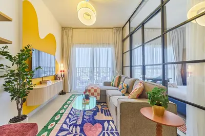 a living room with a couch and a table at Colorful1BR Apartment in Dubai Hills Next to Mall in Dubai