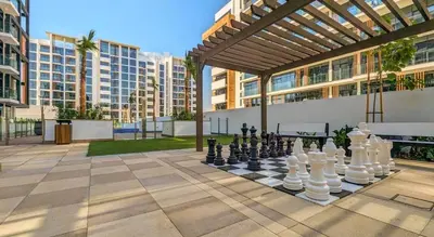 a chess game on a chess board in a courtyard at Bright Studio in Azizi Riviera Perfect Getaway in Dubai