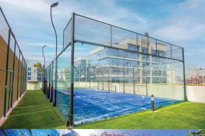 a tennis court in front of a building at Bloomfields Elegant Stu Jewelz in Dubai