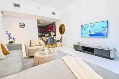a living room with a couch and a tv at Iconic Sea View Marina - LUX NEW in Dubai