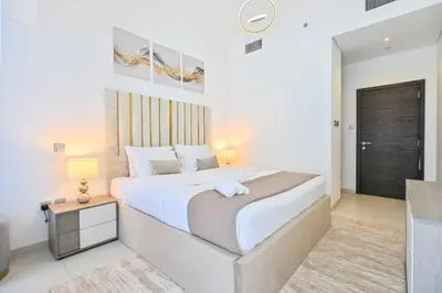a white bedroom with a large bed and a table at Iconic Sea View Marina - LUX NEW in Dubai