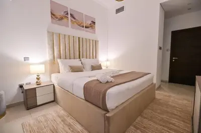 a bedroom with a large bed and a table with a lamp at Iconic Sea View Marina - LUX NEW in Dubai