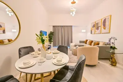 a living room with a table and chairs and a couch at Iconic Sea View Marina - LUX NEW in Dubai