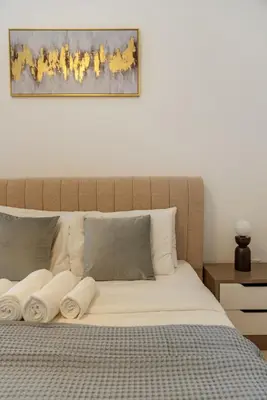 a bedroom with a large bed with white sheets at ShoresInn - Elite 1BR in Dubai Marina in Dubai