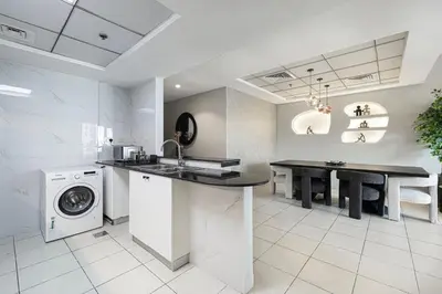 a kitchen with a sink and a washing machine at 2BR Steps from JBR Beach in Dubai