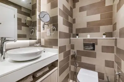 a bathroom with a sink and a mirror at Cozy studio in Seven Palm in Dubai