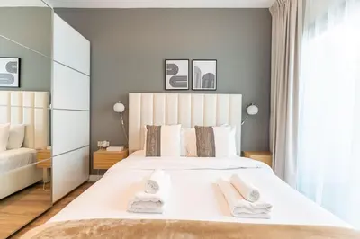 a bedroom with a white bed with two towels on it at Central 1BR in Marina with Private Terrace & Pool in Dubai
