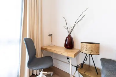 a desk with two chairs and a vase on it at Central 1BR in Marina with Private Terrace & Pool in Dubai