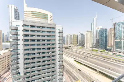 a city skyline with tall buildings and a highway at Central 1BR in Marina with Private Terrace & Pool in Dubai