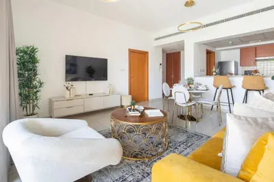 a living room with a couch and a table at Frank Porter - Al Arta 4 in Dubai