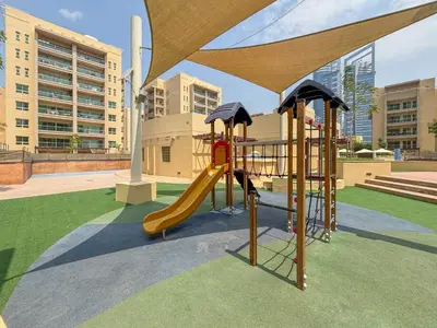 a playground with a slide in a park at Frank Porter - Al Arta 4 in Dubai