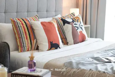 a bedroom with a bed with pillows on it at Manzil - Stylish living in JVC, City Views and Pool in Dubai