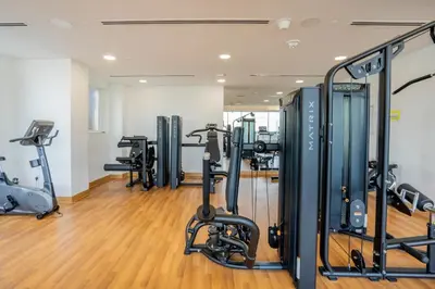 a gym with treadmills and exercise equipment at Manzil - Stylish living in JVC, City Views and Pool in Dubai
