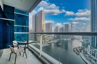 a balcony with a view of a river and buildings at ShoresInn - Stellar 2BR with charming Marina View in Dubai