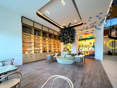 a store with tables and chairs in a room at Cozy 1 Bedroom in Golfville Dubai Hills in Dubai