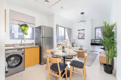 a kitchen and living room with a table and chairs at Mystic - Stylish High-Rise Living with Premium Amenities in Dubai