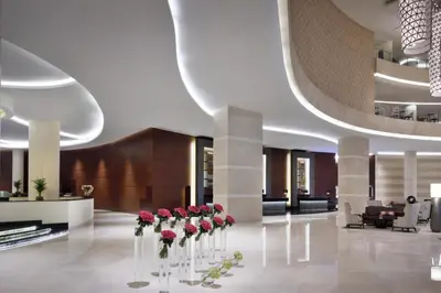 a lobby with red roses in vases on the floor at The Elegant Escape in Dubai