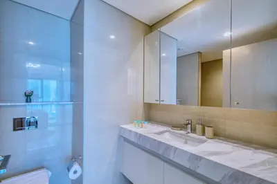 a bathroom with a sink and a mirror at Burj Royale - Luxury Stay with Panoramic Burj Khalifa & Fountain View in Dubai