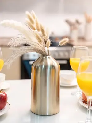 a metal kettle on a table with two glasses of orange juice at Stunning Panoramic Sea & Marina Skyline View in Dubai