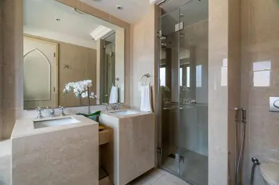 a bathroom with two sinks and a shower at GuestReady - Downtown lux near Burj Khalifa in Dubai