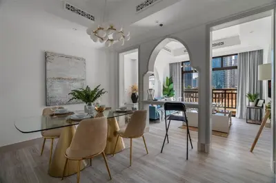 a dining room with a glass table and chairs at GuestReady - Downtown lux near Burj Khalifa in Dubai