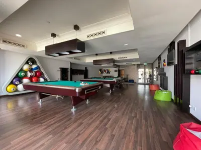 two billiards tables in a room with a pool table at GuestReady - Downtown lux near Burj Khalifa in Dubai