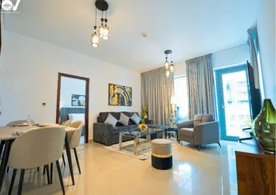 a living room with a couch and a table at Luxurious 2BR I Burj Khalifa View I Downtown Dubai in Dubai