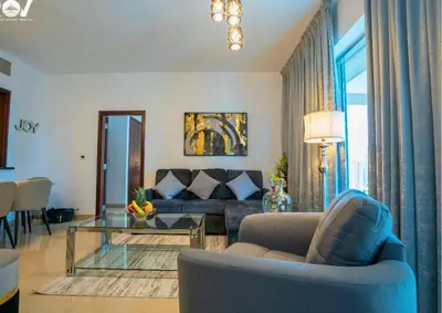 a living room with a couch and a glass table at Luxurious 2BR I Burj Khalifa View I Downtown Dubai in Dubai