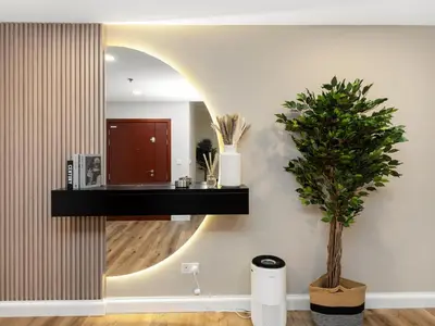 a room with a mirror and a potted plant at Elegant Dubai Eye Beach Retreat in Dubai