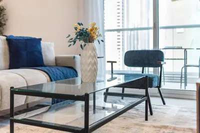 a living room with a glass coffee table and a couch at ShoresInn - Stunning 1BR with Marina View in Dubai