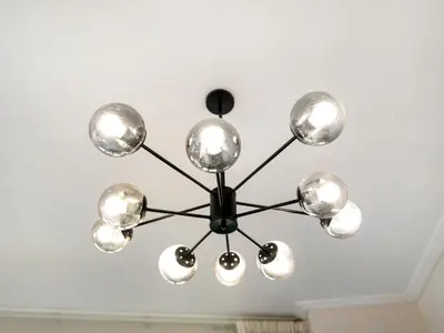 a chandelier hanging from a ceiling in a room at Bespoke 1 Bedroom Apartment I Burj Khalifa & Fountain Views I Free Gym, Pool, Wi-Fi, Parking & PS5 I by Skyline Serenity in Dubai