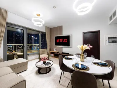 a living room with a couch and a table at New Burj Khalifa & Fountain Views & Work station in Dubai